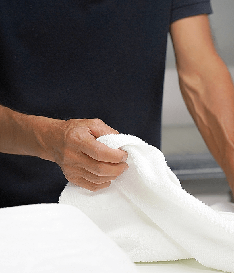 man folding towel